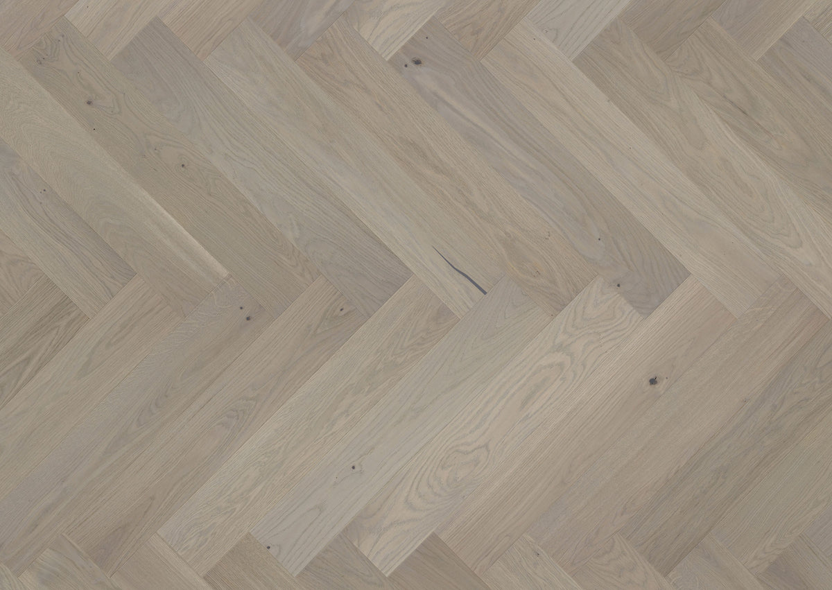 Luxury light wood flooring laid in herringbone pattern