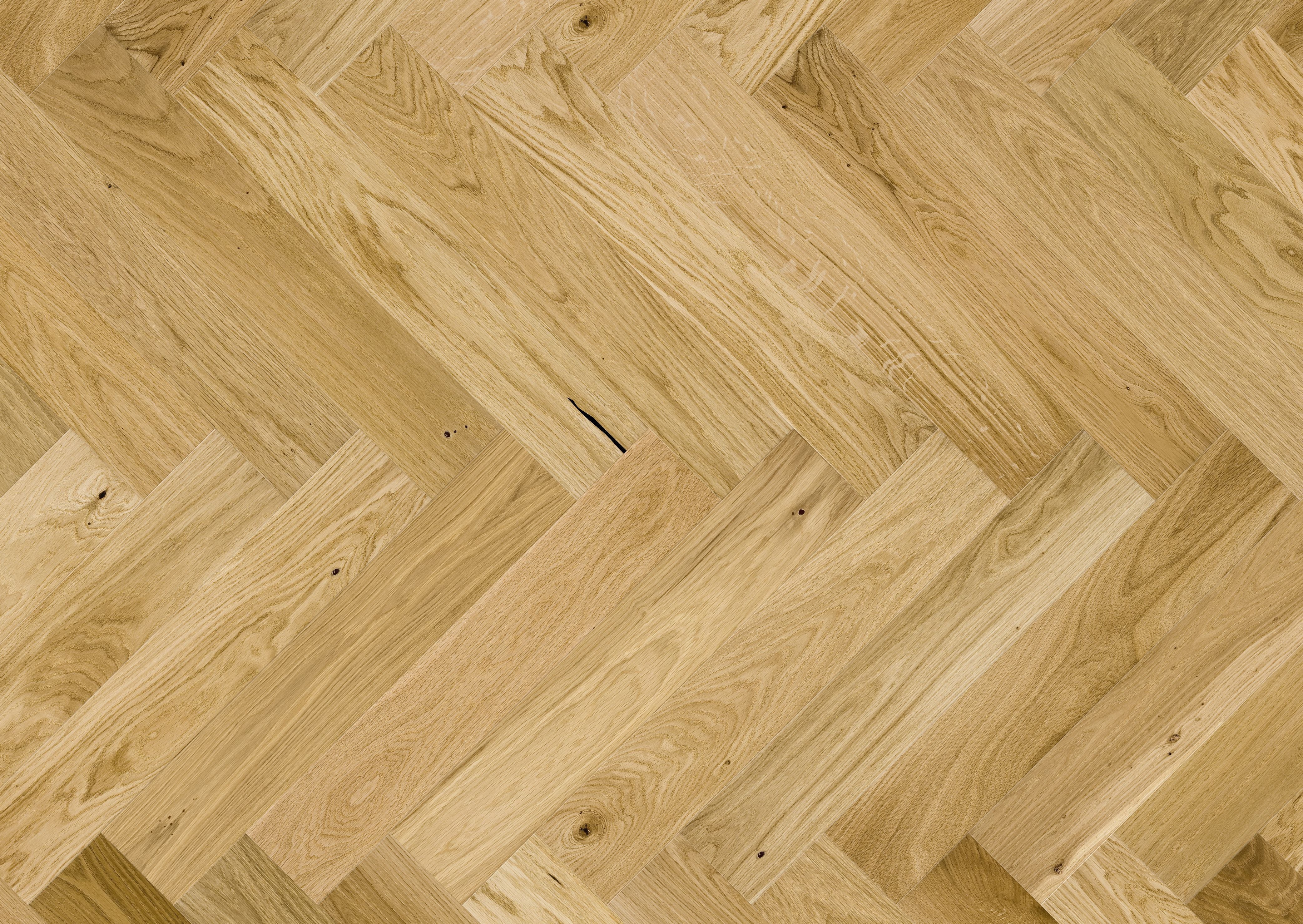 Natural wood flooring laid in herringbone pattern