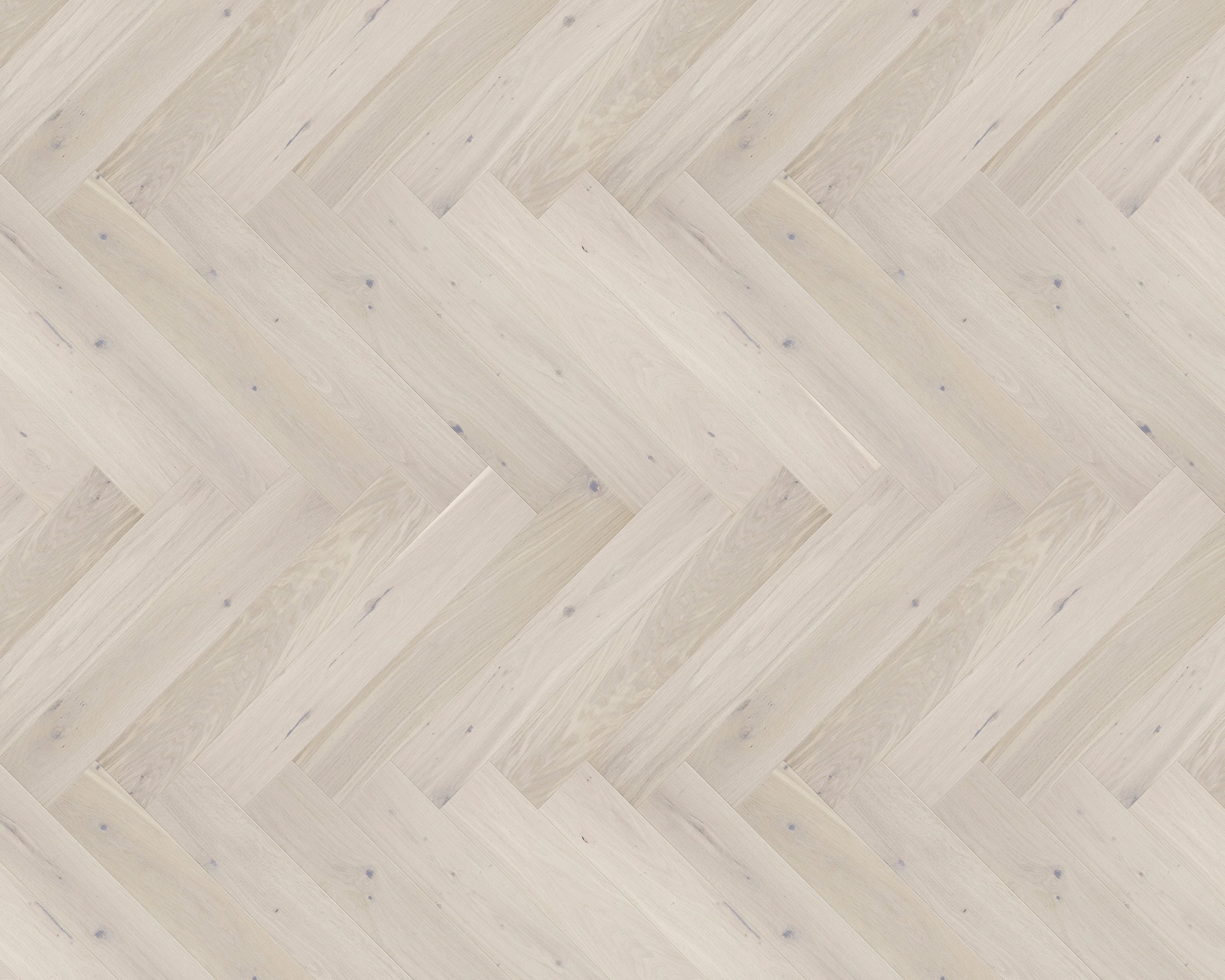 Light wood flooring laid in herringbone pattern